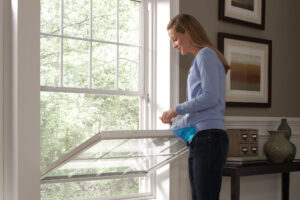 Woman Cleaning a Doub-Hung Window