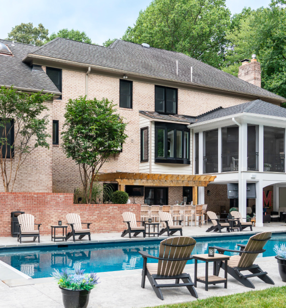 Potomac Hp windows in True Black overlooking a pool on a brick home.
