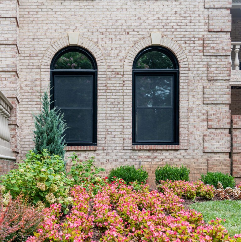 Double hung windows with arches in True Black. Click to explore our Potomac window series.